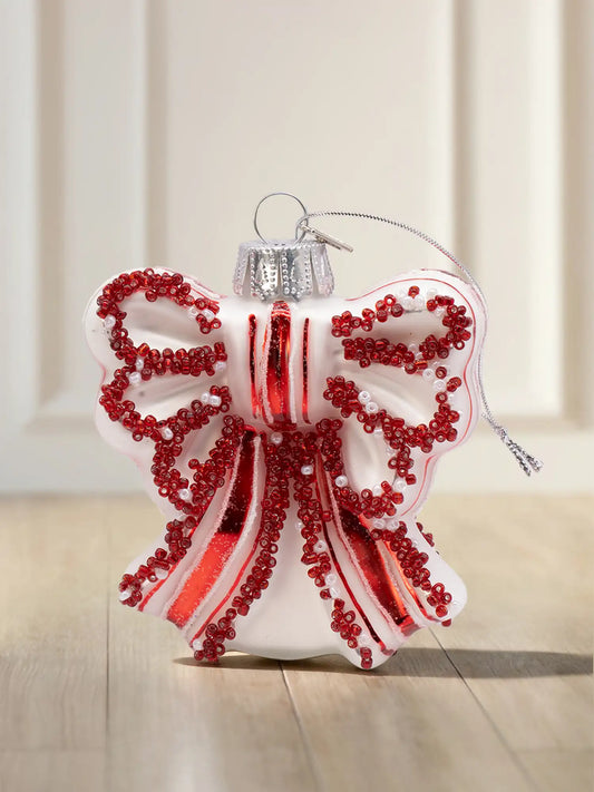 Glasornament in Form eines rot-weiß gestreiften Leuchtturms auf einem Felssockel mit blauen Wellen und silberner Aufhängung.